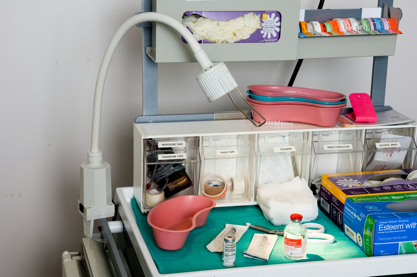Medical utility cart stocked with supplies in a hospital.
