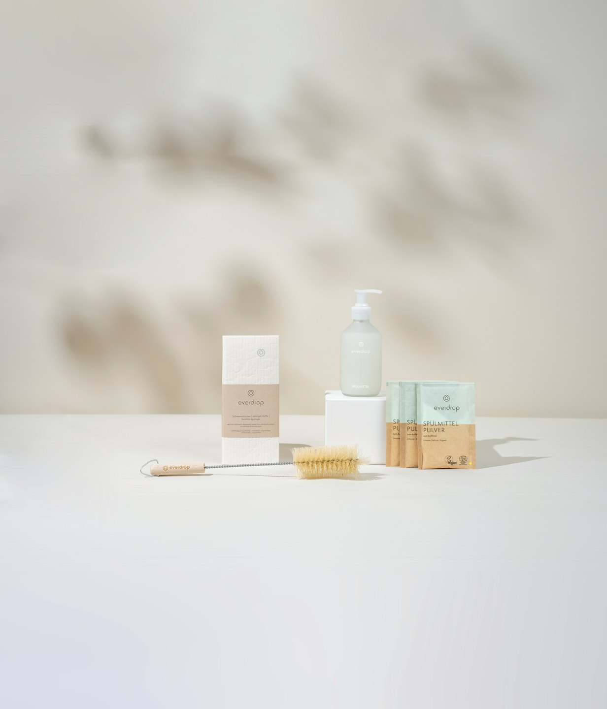 Eco-friendly cleaning products arranged on a white surface.